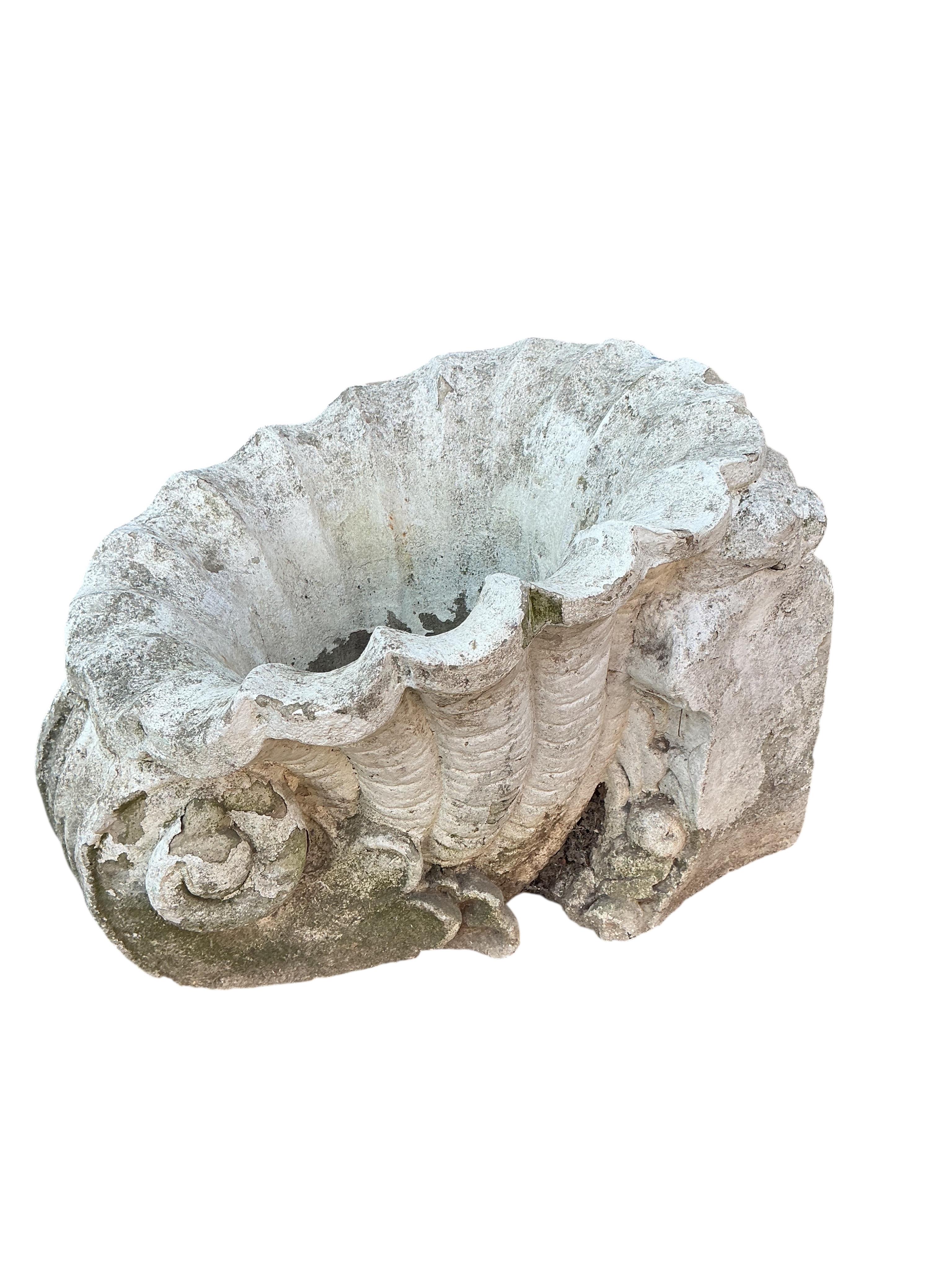 A pair of reconstituted shell style garden planters, width 39cm, height 32cm.
